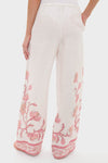 Hibiscus Bloom Pink Florentine Pants showcase a classic, effortless style with a fun pink floral border, elastic waistband, and side pockets for high-end comfort.