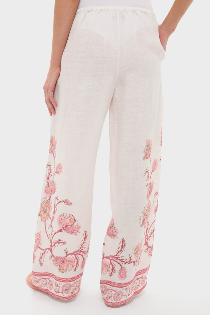 Hibiscus Bloom Pink Florentine Pants showcase a classic, effortless style with a fun pink floral border, elastic waistband, and side pockets for high-end comfort.