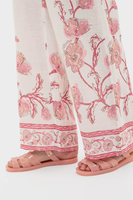 Effortlessly stylish Hibiscus Bloom Pink Florentine Pants, showcasing a classic wide-leg design with fun floral prints, paired with pink jelly sandals for a high-end look.