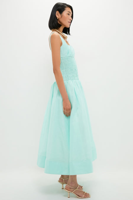 Effortlessly chic, the Mint Green Linen Organza Midi Dress features a classic A-line silhouette with a smocked bodice, drop waist, and full skirt, epitomizing high-end fashion.