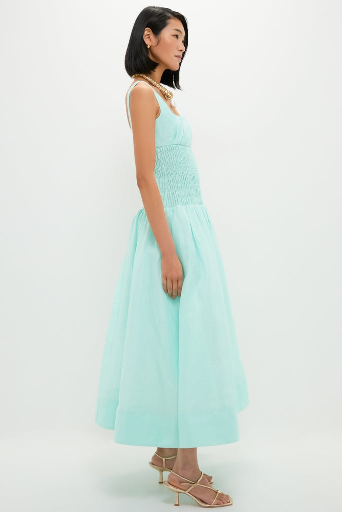 Effortlessly chic, the Mint Green Linen Organza Midi Dress features a classic A-line silhouette with a smocked bodice, drop waist, and full skirt, epitomizing high-end fashion.