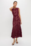 Woman models the classic Burgundy Guipure Lace Midi Dress; an effortlessly high-end piece with a fitted bodice and flared scalloped hem, paired with black heels.