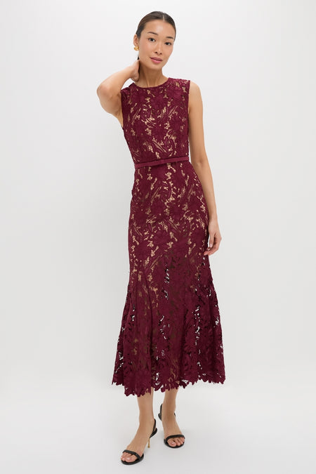 Woman models the classic Burgundy Guipure Lace Midi Dress; an effortlessly high-end piece with a fitted bodice and flared scalloped hem, paired with black heels.