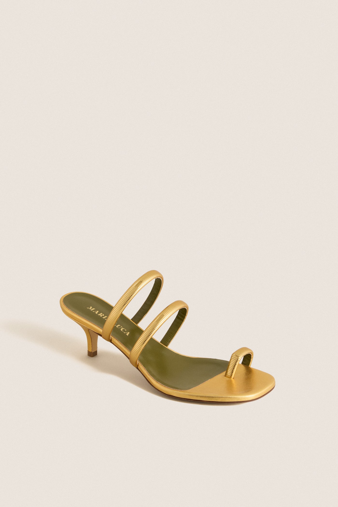 Gold Modia Sandals: Classic metallic gold sandal with a kitten heel, featuring effortless toe and foot straps for a fun, high-end finish. Perfect for elevating any outfit.