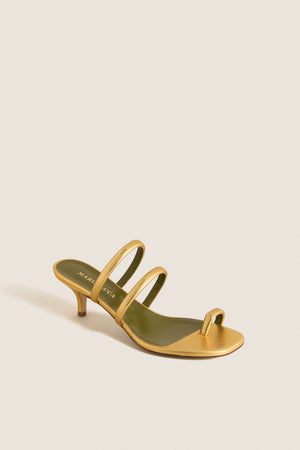 Gold Modia Sandals: Classic metallic gold sandal with a kitten heel, featuring effortless toe and foot straps for a fun, high-end finish. Perfect for elevating any outfit.