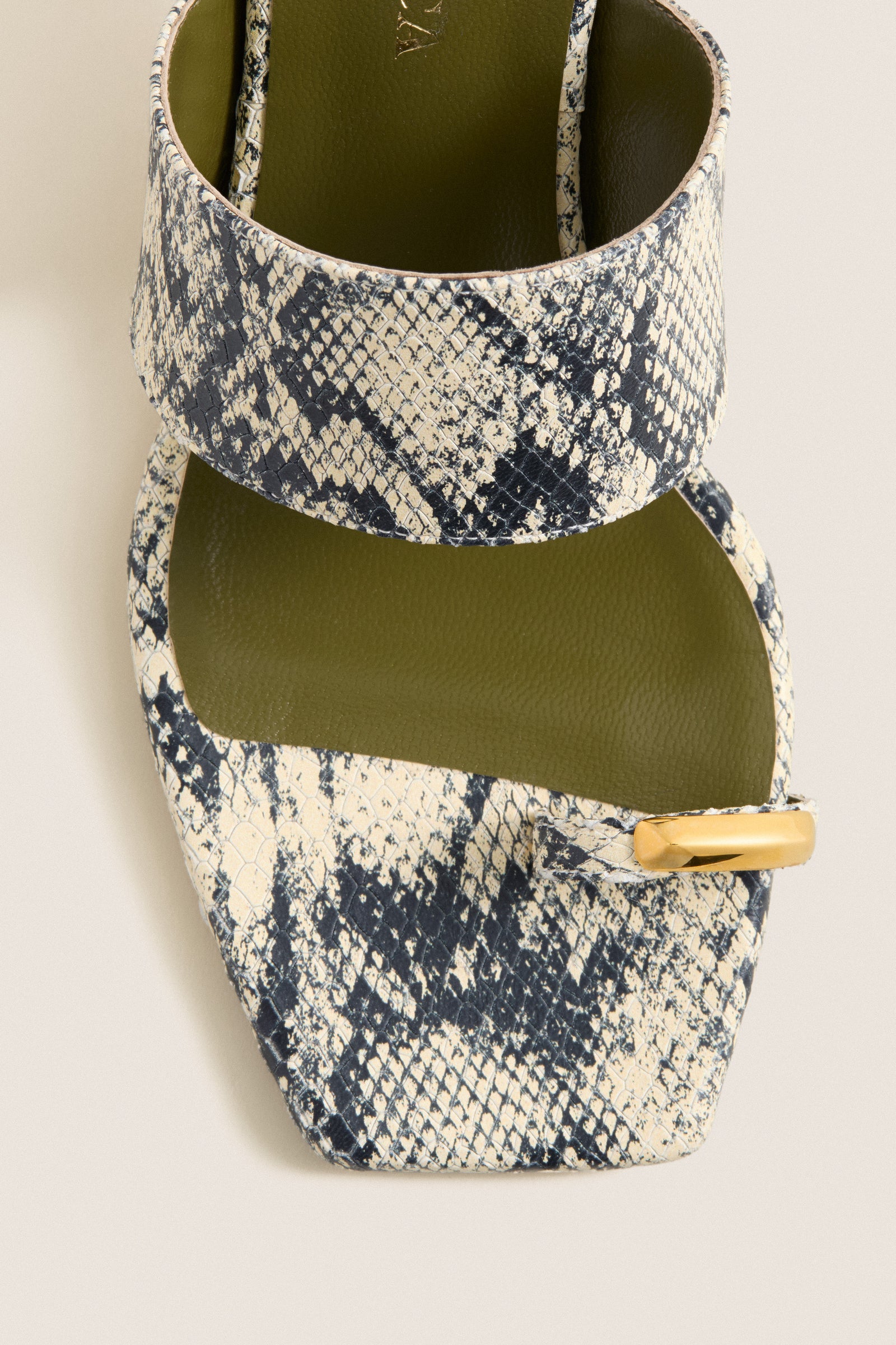 Natural Snake Olympia Block Heel Mules feature a classic, effortless design with a snakeskin-print strap, gold-accented toe loop, and olive footbed for a fun, high-end look.