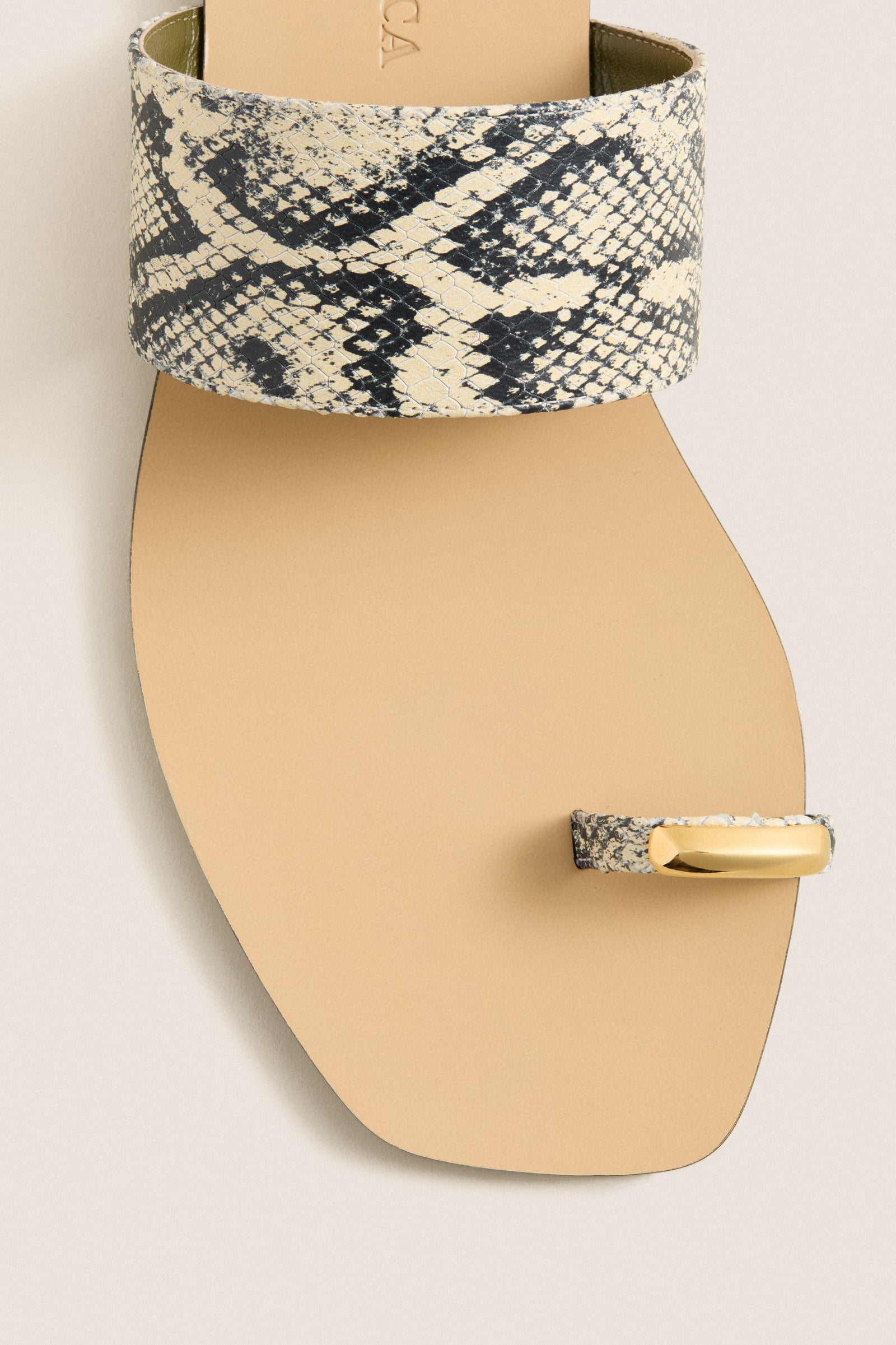 Natural Snake Oleandrea Capri Flat Sandals: Classic flat sandal with a sleek snakeskin strap and gold metal toe post, offering effortless, high-end style for fun, everyday wear.