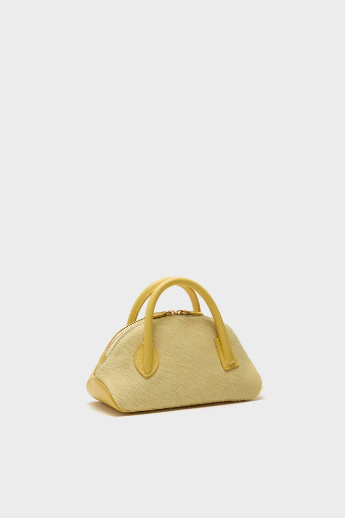Butter EW Dome Clutch, a classic, dome-shaped handbag with a textured surface, featuring effortless top-handles and zip closure, embodies high-end style and fun sophistication.