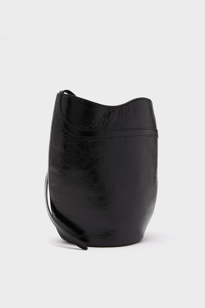 Black Glossy Belted Bucket Bag in high-end glossy leather, featuring a classic, effortless design with a rounded base and single shoulder strap for fun, stylish wear.