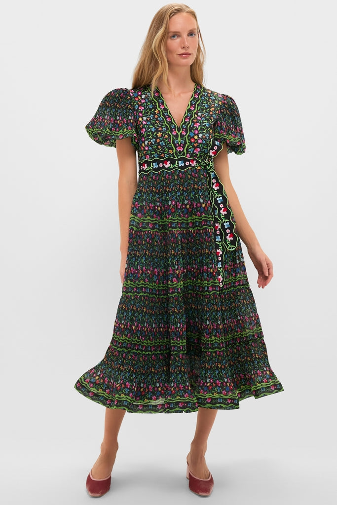 Model wearing the classic Black Celestia Dress, featuring effortless puff sleeves, fun floral patterns, and a high-end smocked design with a detailed removable belt.