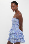 Model wearing the Blue Elodie Dress, a classic, effortless mini dress with a smocked bodice and tiered skirt, embodying a fun and high-end style.