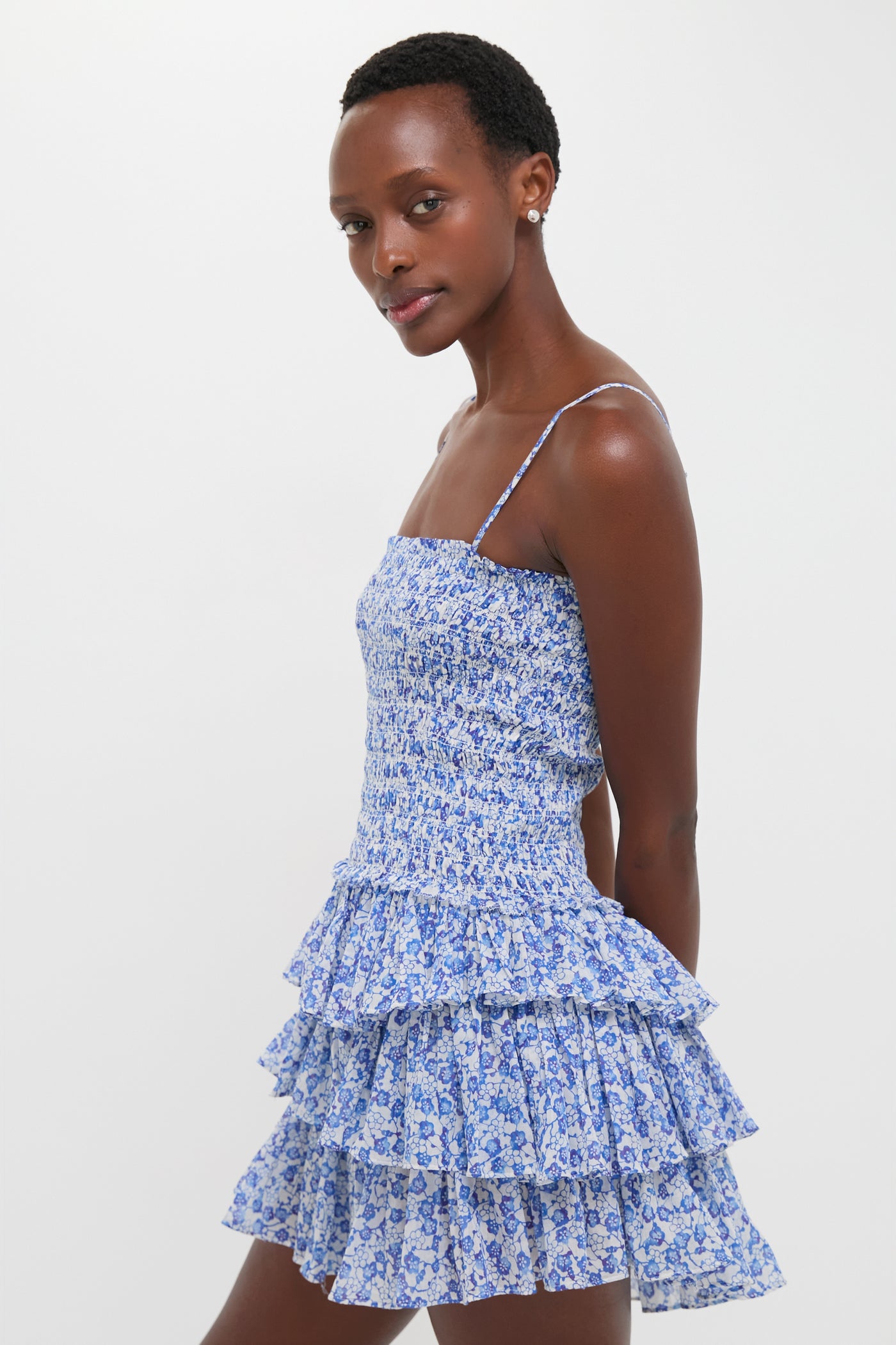 Model wearing the Blue Elodie Dress, a classic, effortless mini dress with a smocked bodice and tiered skirt, embodying a fun and high-end style.
