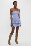 Blue Elodie Dress: A classic, effortless mini with a smocked bodice and tiered skirt, paired with tan-suede cowboy boots for a fun, high-end look.