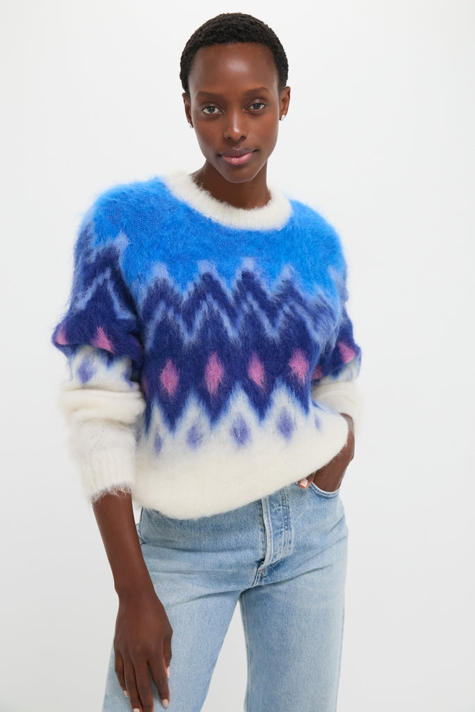 Model wearing the Blue Ambre Sweater, a classic fair isle pullover with a relaxed fit, perfectly paired with light-wash jeans for an effortless, high-end look.