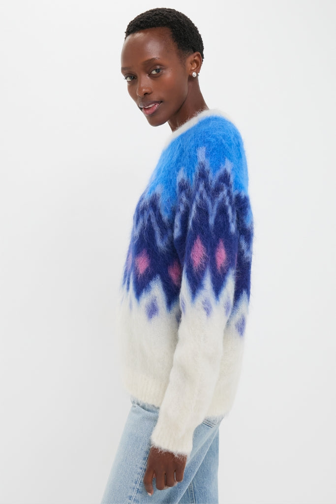 Person wearing the Blue Ambre Sweater with a classic fair isle pattern, effortlessly paired with light-wash jeans. A chic, high-end, and fun winter essential.