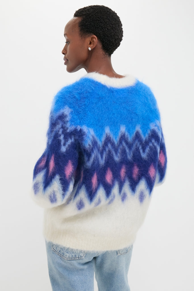 Effortlessly chic Blue Ambre Sweater in fair isle pattern, featuring a classic relaxed fit, paired with light-wash jeans for a fun, high-end look.