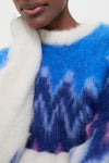 Person wearing the Blue Ambre Sweater with a classic fair isle zigzag pattern, showcasing its effortless, high-end style and fun, cozy mohair texture.
