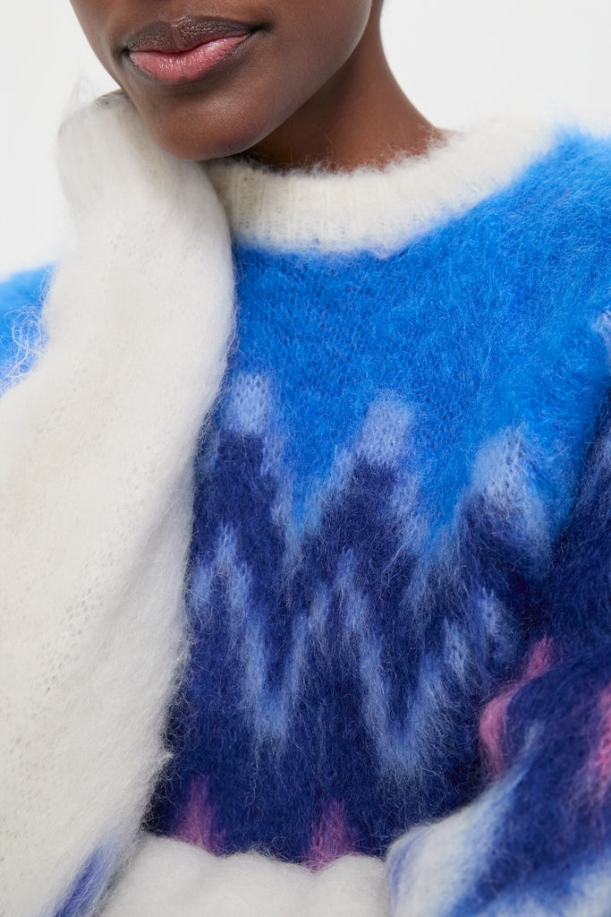 Person wearing the Blue Ambre Sweater with a classic fair isle zigzag pattern, showcasing its effortless, high-end style and fun, cozy mohair texture.