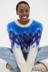 Person smiling in a classic Blue Ambre Sweater with a chic fair isle design, embodying effortless style. Perfect for fun, high-end casual outings or cozy lounging.
