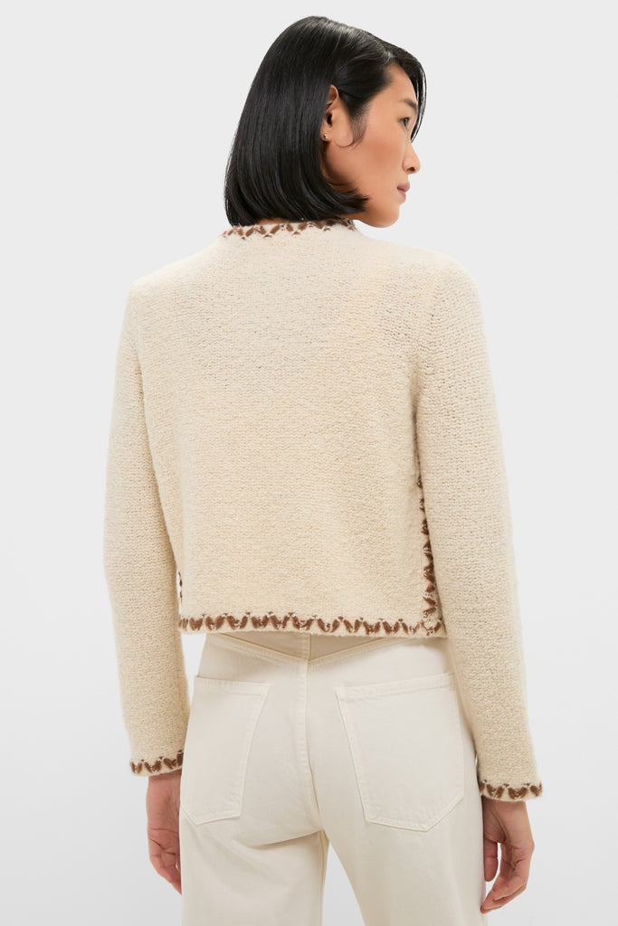 Ecru and Bronze Rochelle Cardigan with boucle texture and contrasting trim, paired with high-waisted jeans; embodies a classic, effortless, and high-end style for a fun, confident look.