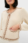 Ecru and Bronze Rochelle Cardigan: A classic, high-end bouclé cardigan with contrasting whip-stitched trim, round neckline, and patch pockets, exuding effortless style and fun elegance.
