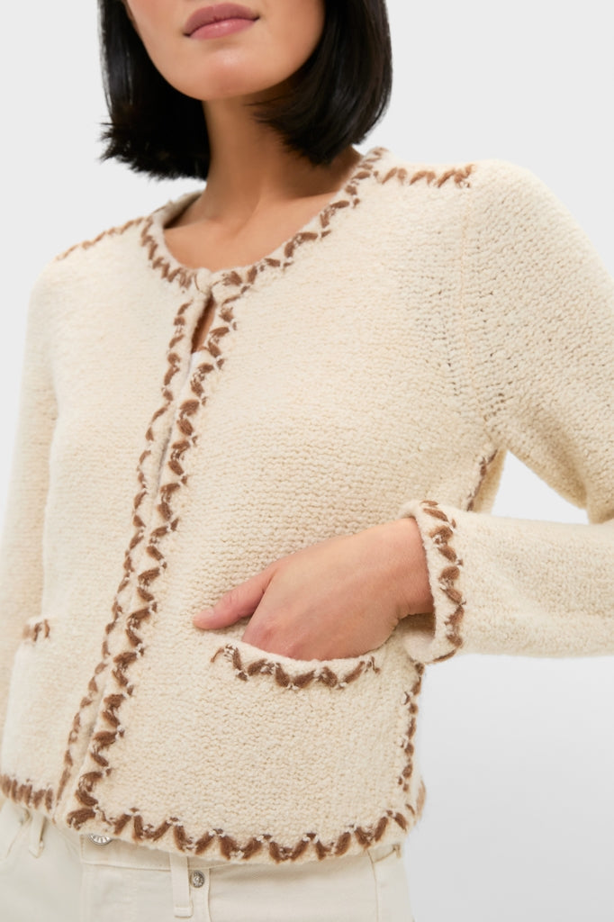 Ecru and Bronze Rochelle Cardigan: A classic, high-end bouclé cardigan with contrasting whip-stitched trim, round neckline, and patch pockets, exuding effortless style and fun elegance.
