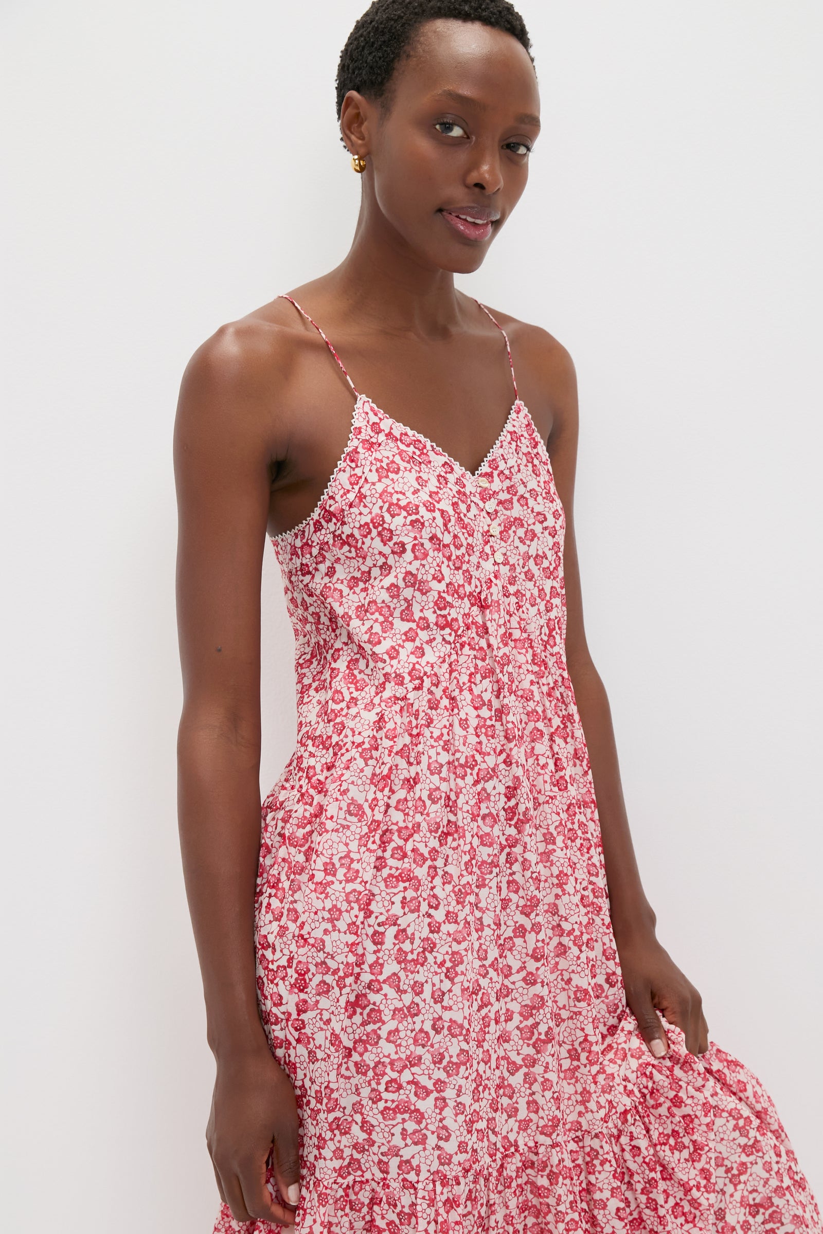 Effortlessly chic, the Red Sabba Dress features a classic, tiered design with a fun floral pattern, perfect for high-end, warm-weather outings.