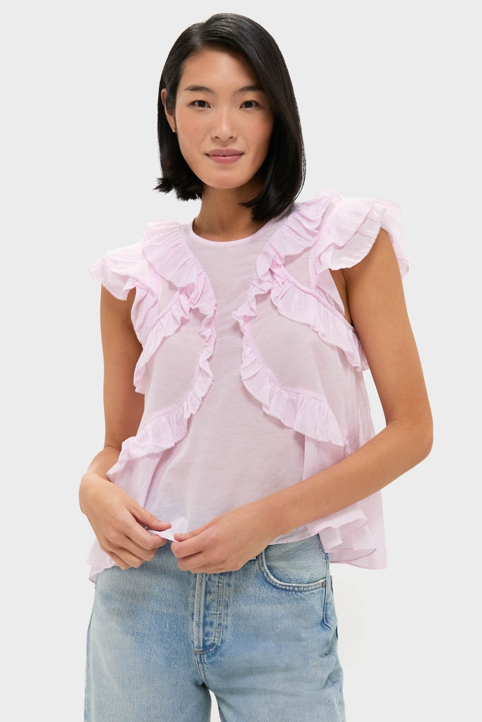 Model wearing the classic Light Pink Nalou Top with ruffle accents and flutter sleeves, paired with light-wash jeans for an effortless, high-end, and fun look.