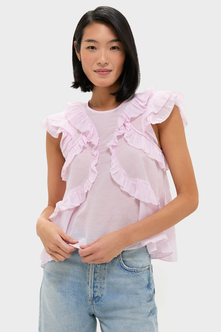 Model wearing the classic Light Pink Nalou Top with ruffle accents and flutter sleeves, paired with light-wash jeans for an effortless, high-end, and fun look.