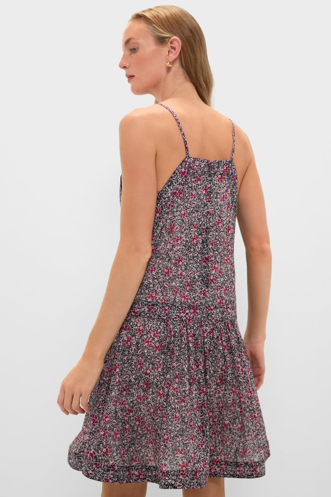 Young woman in a sleeveless Crushed Berry Danielle Dress with a classic, effortless floral print and tiered skirt, embodying fun and high-end style.