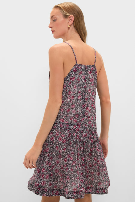 Young woman in a sleeveless Crushed Berry Danielle Dress with a classic, effortless floral print and tiered skirt, embodying fun and high-end style.
