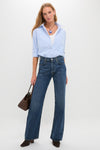 Westwood Annina Straight Leg jeans in deep indigo, styled with a classic striped shirt and suede boots, showcasing an effortless, high-end look for modern, fun sophistication.