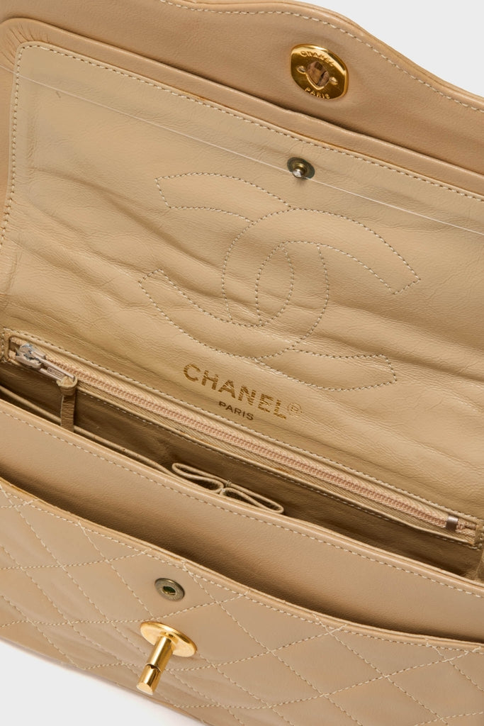 CHANEL CC Mini Paris Double Flap Bag interior showcasing classic interlocking CC logo, gold-tone hardware, and organized compartments, embodying effortless high-end style for fun, confident living.