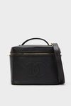 CHANEL Large Caviar Vanity Bag, a classic, structured black leather piece with a gold-tone zipper, top handle, shoulder strap, and embossed interlocking “CC” logo, exudes effortless, high-end style.