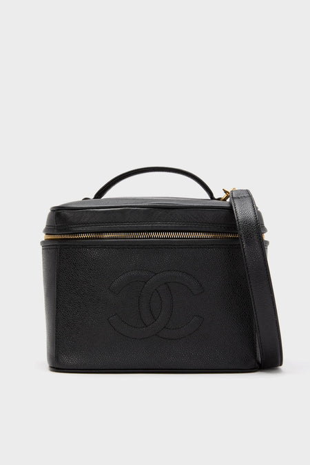 CHANEL Large Caviar Vanity Bag, a classic, structured black leather piece with a gold-tone zipper, top handle, shoulder strap, and embossed interlocking “CC” logo, exudes effortless, high-end style.