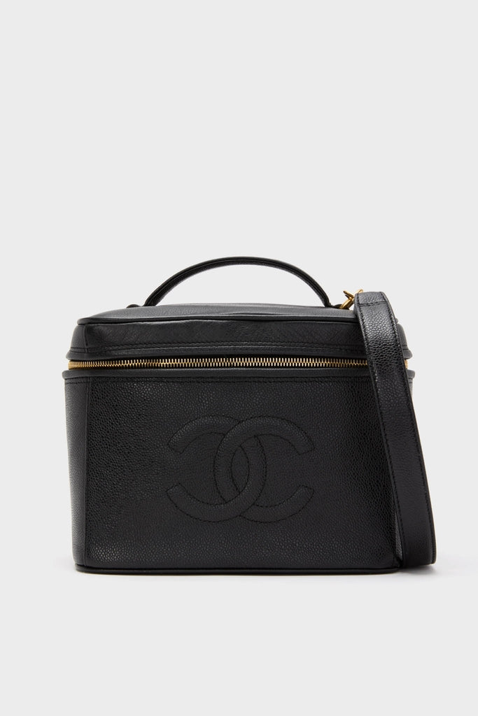 CHANEL Large Caviar Vanity Bag, a classic, structured black leather piece with a gold-tone zipper, top handle, shoulder strap, and embossed interlocking “CC” logo, exudes effortless, high-end style.