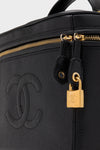 CHANEL Large Caviar Vanity Bag in black pebbled leather, featuring a classic interlocking “CC” logo, gold-tone zipper, and padlock, embodying effortless, high-end style.