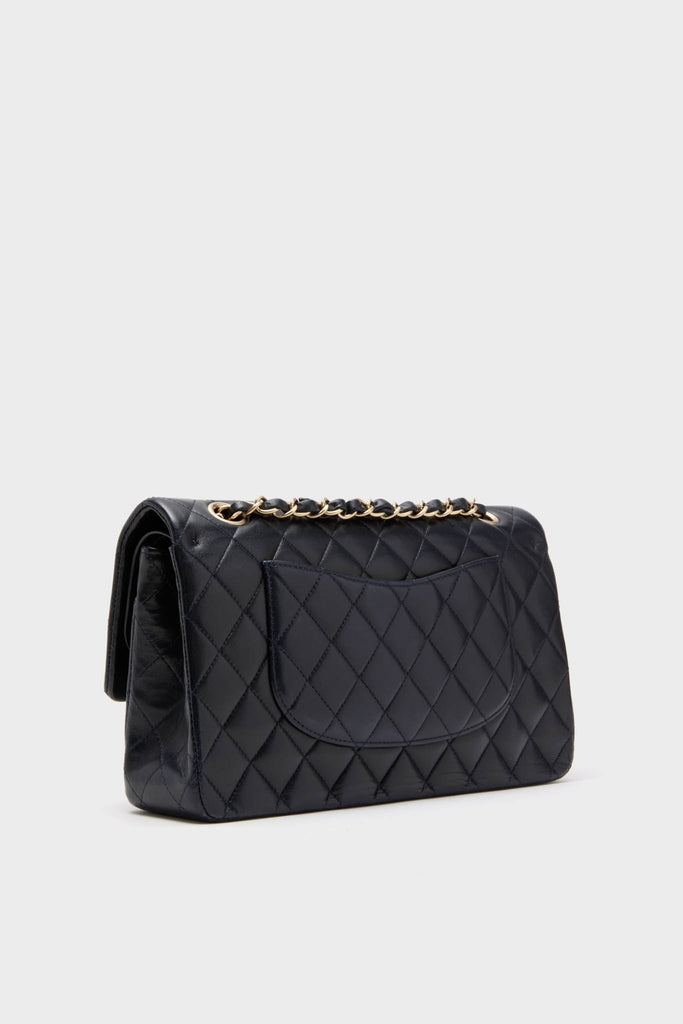 CHANEL Navy Blue Lambskin Double Flap: A classic, high-end quilted leather shoulder bag featuring a diamond-stitch pattern and effortless gold-tone chain strap, perfect for fun, confident style.