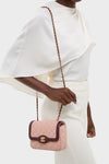 Effortlessly chic, the CHANEL Pink Lambskin Quilted Mini Two Tone Day Flap Shoulder Bag exudes high-end style with its classic gold CC clasp and fun chain strap.