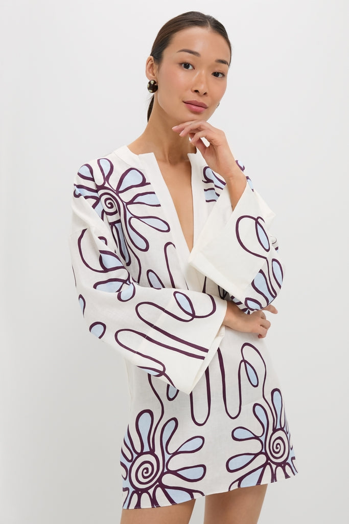 Namur Celeste Siena Dress: A classic, effortless tunic-style mini with a deep V-neck, kimono sleeves, and bold botanical motifs, embodying high-end resortwear elegance.