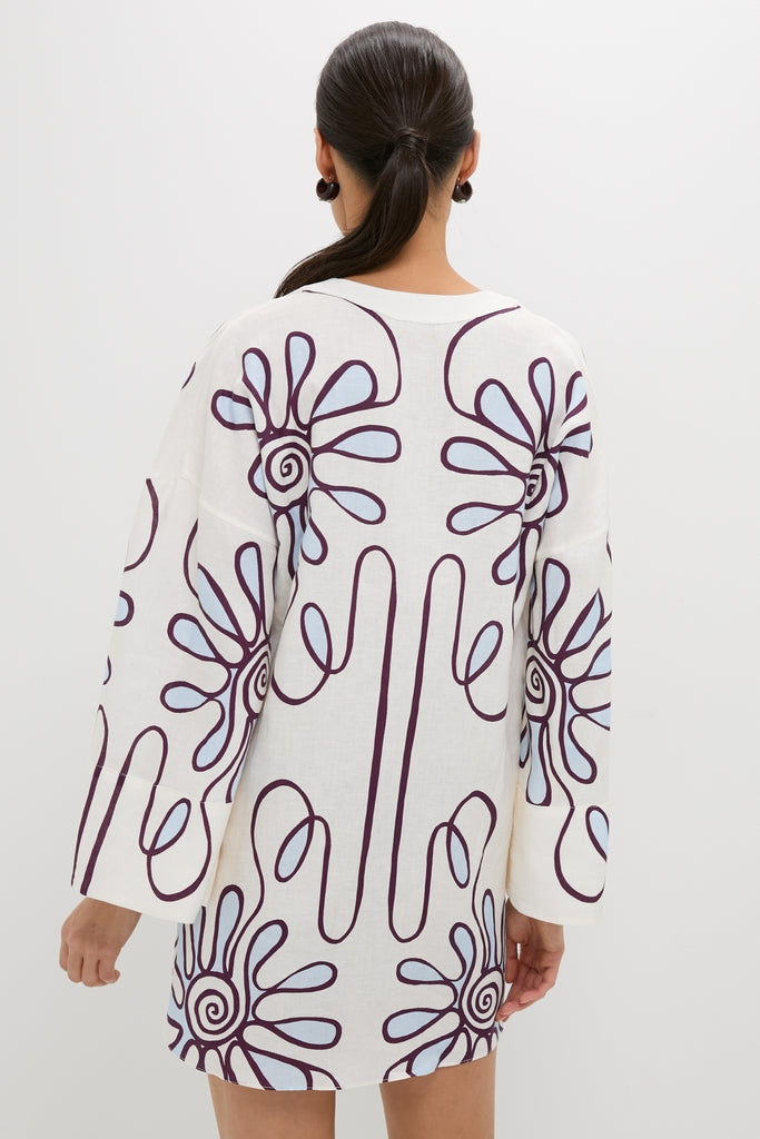 Woman in Namur Celeste Siena Dress, featuring a classic, effortless floral print and kimono sleeves, embodying fun high-end resortwear style.