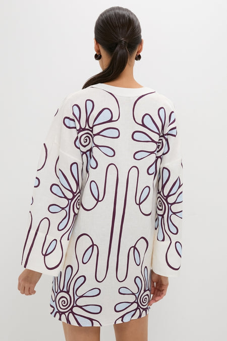 Woman in Namur Celeste Siena Dress, featuring a classic, effortless floral print and kimono sleeves, embodying fun high-end resortwear style.