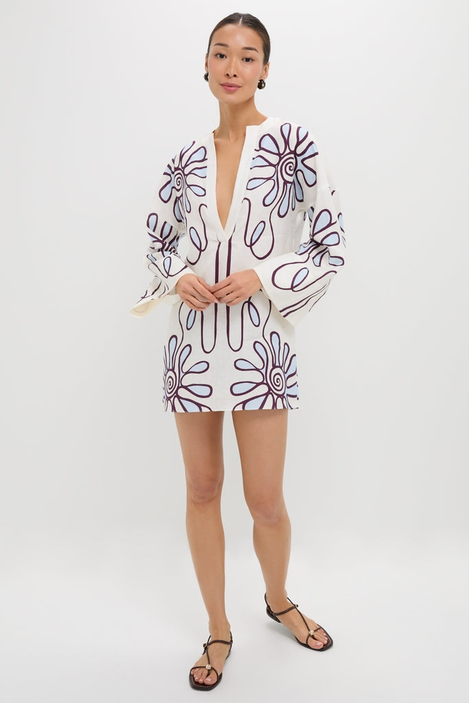 Namur Celeste Siena Dress: A classic, effortless linen tunic with a deep V-neck, kimono sleeves, and bold floral print, styled with black T-strap sandals.