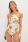 Young woman models the Off-White Balearic Applique Swimsuit, featuring an abstract pattern and a halter neck tie, exuding an effortless, high-end, and fun style.
