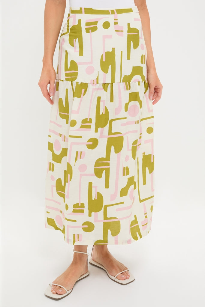 Off-White Balearic Midi Skirt, featuring a classic tiered design with an abstract olive and pale pink print. Paired effortlessly with white strappy sandals for a high-end, fun look.