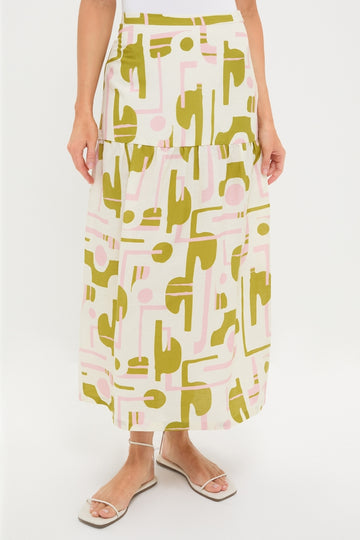 Off-White Balearic Midi Skirt, featuring a classic tiered design with an abstract olive and pale pink print. Paired effortlessly with white strappy sandals for a high-end, fun look.