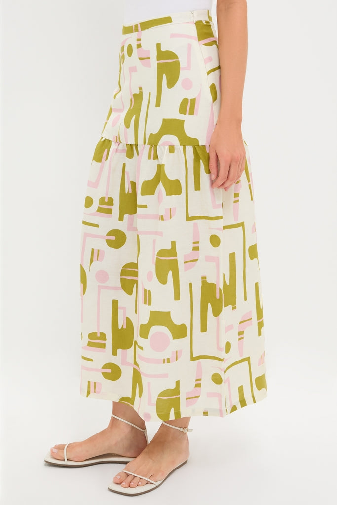 Off-White Balearic Midi Skirt, featuring an abstract olive and pink pattern, exudes classic elegance with effortless style, paired with simple white sandals for a fun, high-end look.