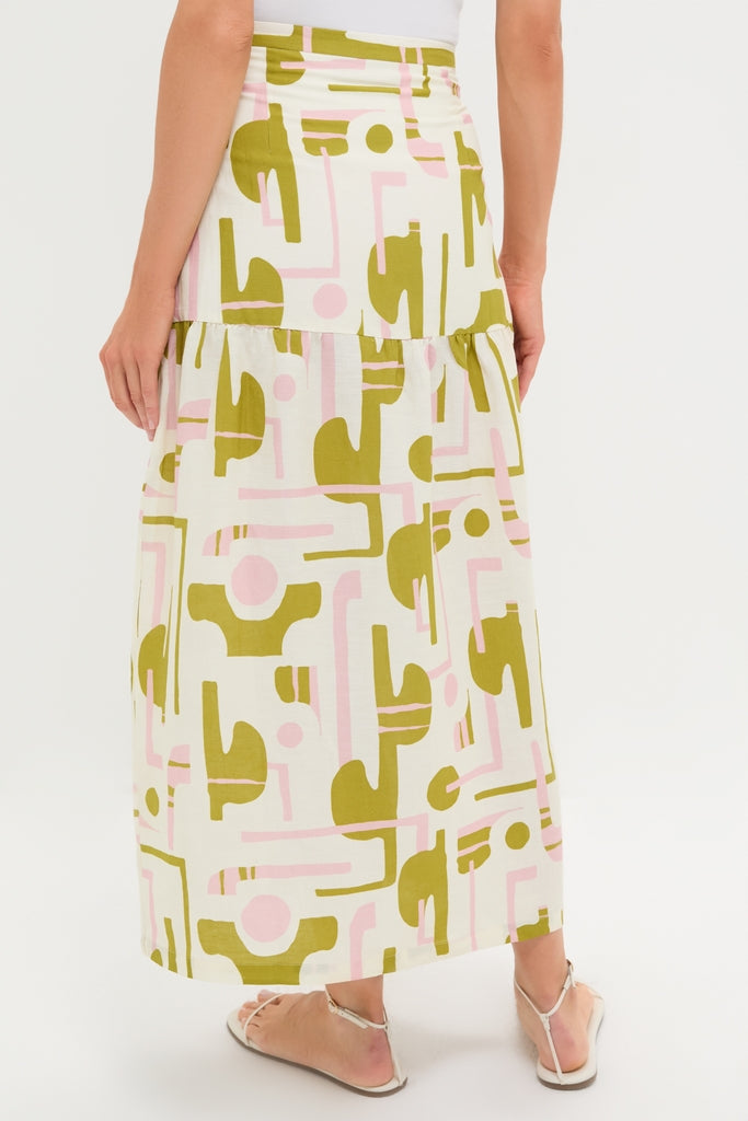 Woman in an Off-White Balearic Midi Skirt, showcasing classic elegance with an abstract pattern. Effortlessly paired with silver sandals, exuding a fun, high-end feel.