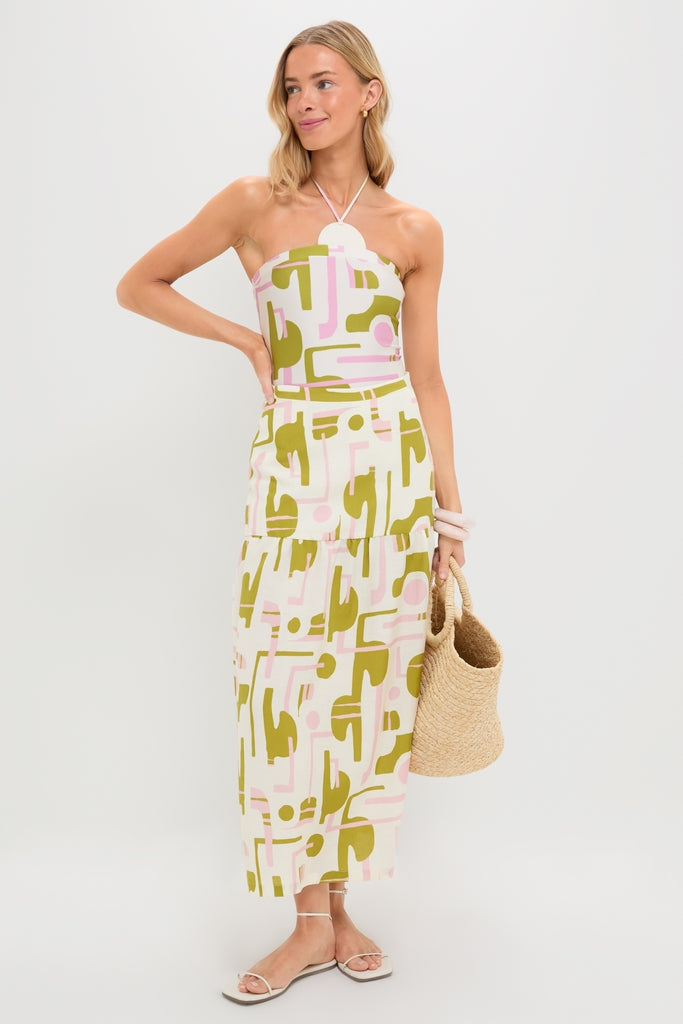 Model wearing the Off-White Balearic Midi Skirt with matching crop top, accessorized with a straw tote, bracelets, and sandals; a classic, effortless high-end summer look.