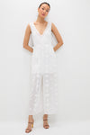 Woman in Off White Aria Embroidery Midi Dress featuring a classic deep V-neck, sheer floral skirt, and effortless tie belt, paired with fun, high-end strappy sandals.